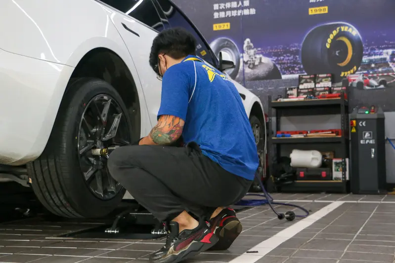 ▲ 技師使用氣動槍，熟練地將鋁圈卸下。